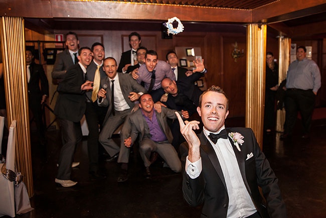 Groom Tossing his Brides Wedding Garter