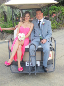 A pretty Bridesmaid wearing Bridal Flip Flops on back of golf cart with Groomsman