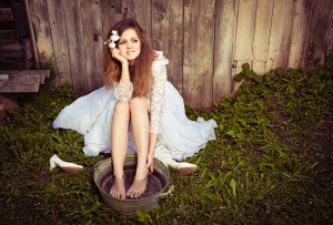 My feet hurt! A Bride has taken off her high heels and is soaking her feet in a pail of water