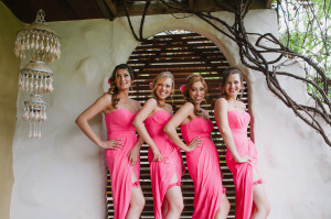 Four pretty Bridesmaids in hot pink dresses and matching garters