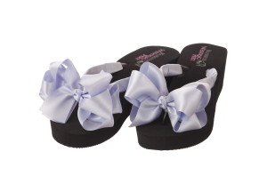 A pair of high wedge bridal flip flops with large boutique blue bows