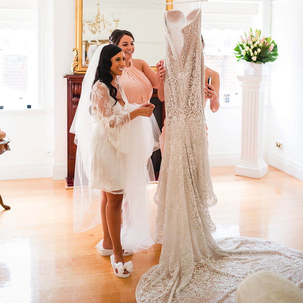 Bride wearing her Bridal Flip Flops and admiring her Wedding Dress