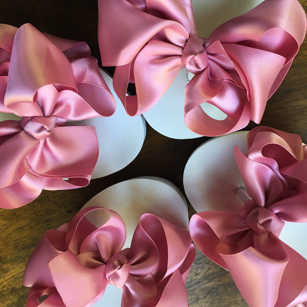 Large dusky pink coloured bows on high wedge heel flip flops