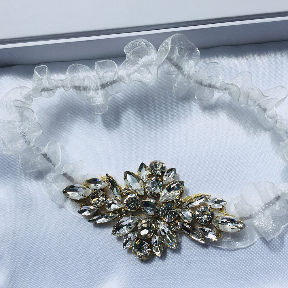 Rhinestones set in gold setting on Bridal Garter